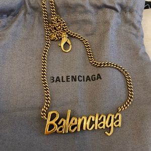 Unisex, gold Balenciaga necklace with box and dust bag.